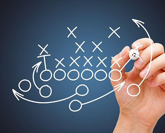 A hand drawing a play diagram